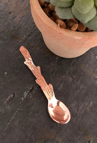 Tiny copper spoon