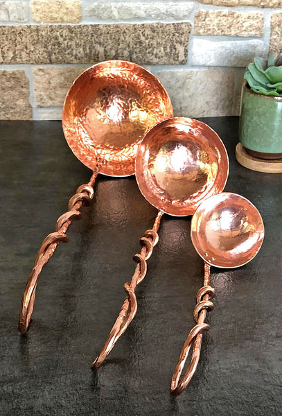 three copper ladles